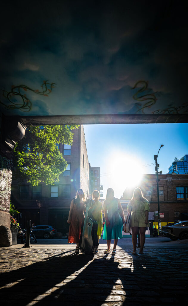 ATLYS walking through a sunlit archway in Chicago